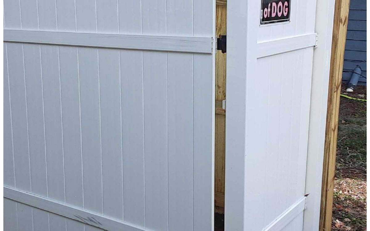 The same white vinyl gate, bright and algae-free after Sandbar soft washing