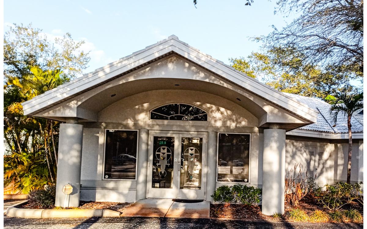 The same HOA clubhouse, bright with a clean white tile roof, after Sandbar soft washing