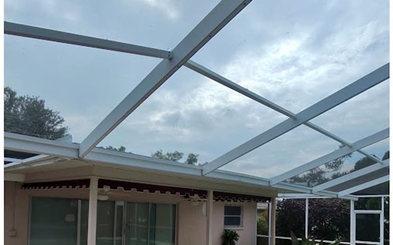 The same pool cage enclosure with a bright, clean white frame after Sandbar cleaning