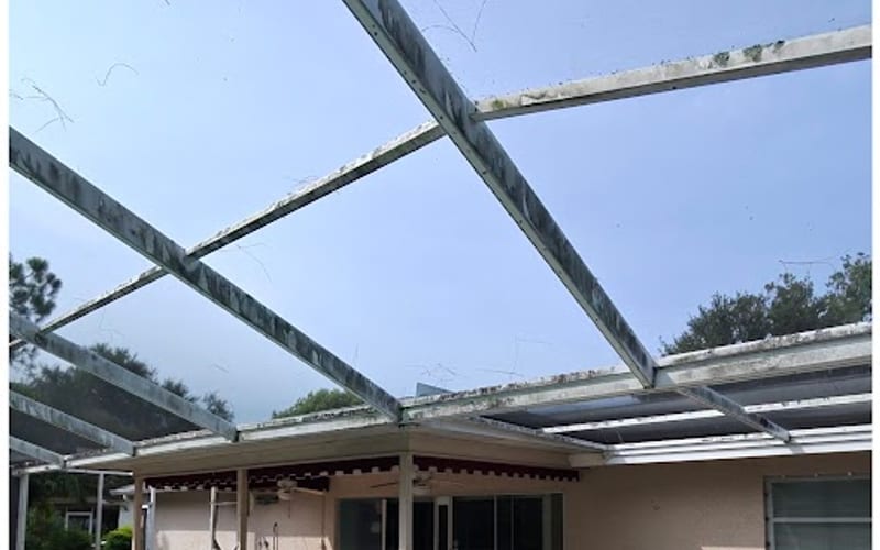Pool cage screen enclosure frame streaked with algae and mildew before Sandbar cleaning — real job photo