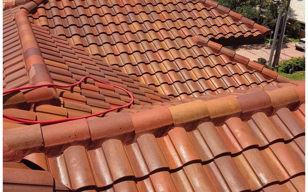 The same tile roof restored to clean terracotta after Sandbar soft washing
