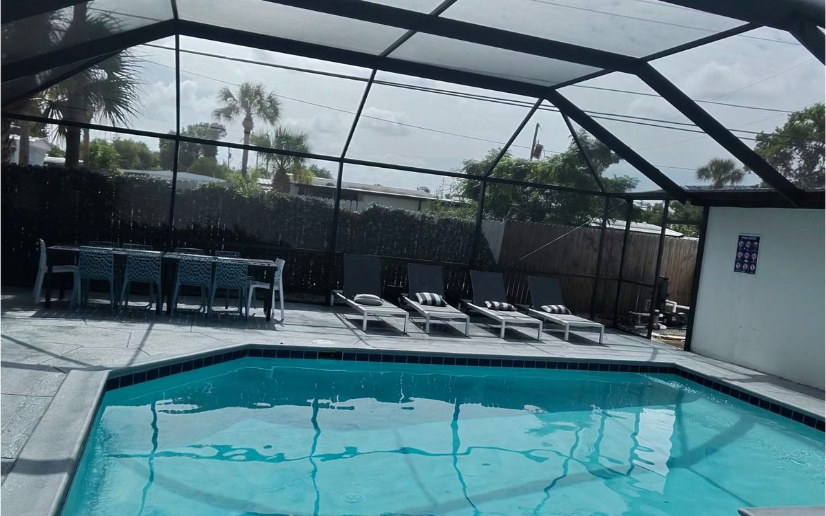 Freshly cleaned screened pool cage interior after a Sandbar visit — real job photo