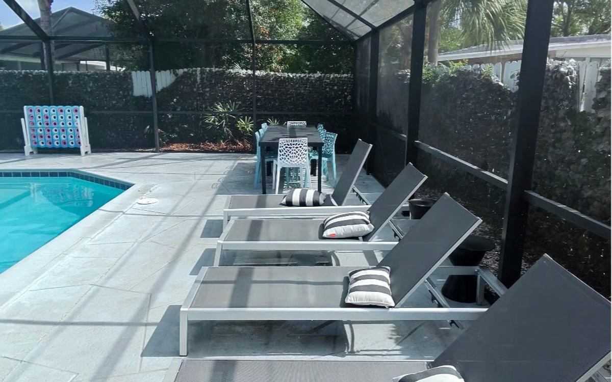 Pool loungers on a freshly cleaned lanai deck after a Sandbar visit — real job photo